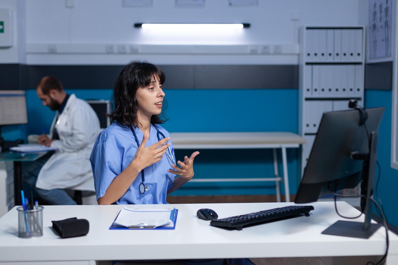Nurse using video call with webcam on computer