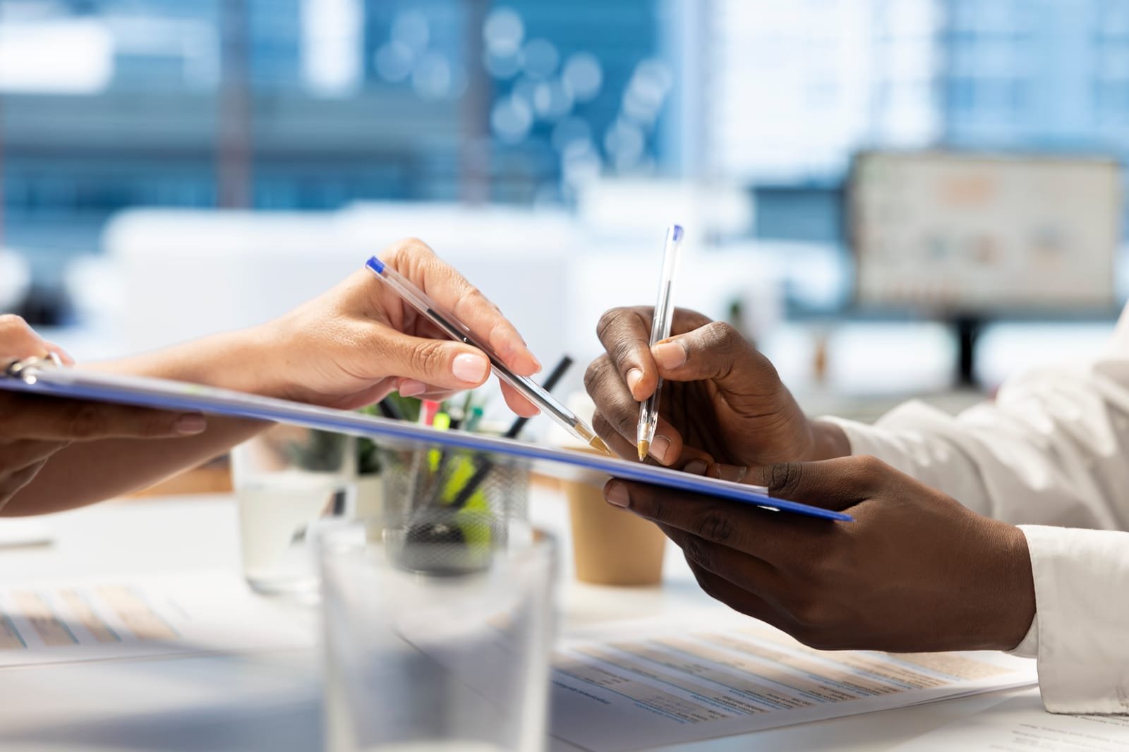 98083216_close-up-of-hr-department-employee-signing-contract-with-person employee screening